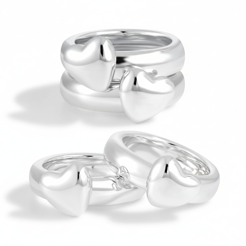 Two silver heart-shaped rings on a white background