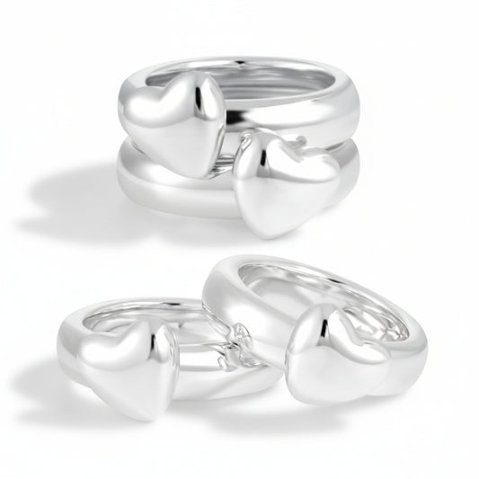 Two silver heart-shaped rings on a white background
