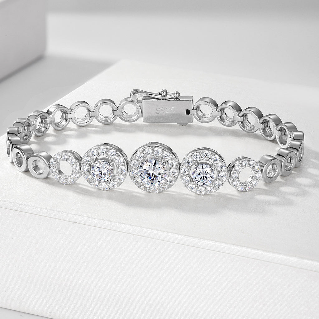 Silver bracelet with diamond-like stones on a white surface