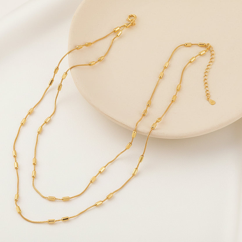 Gold necklace on a neutral background