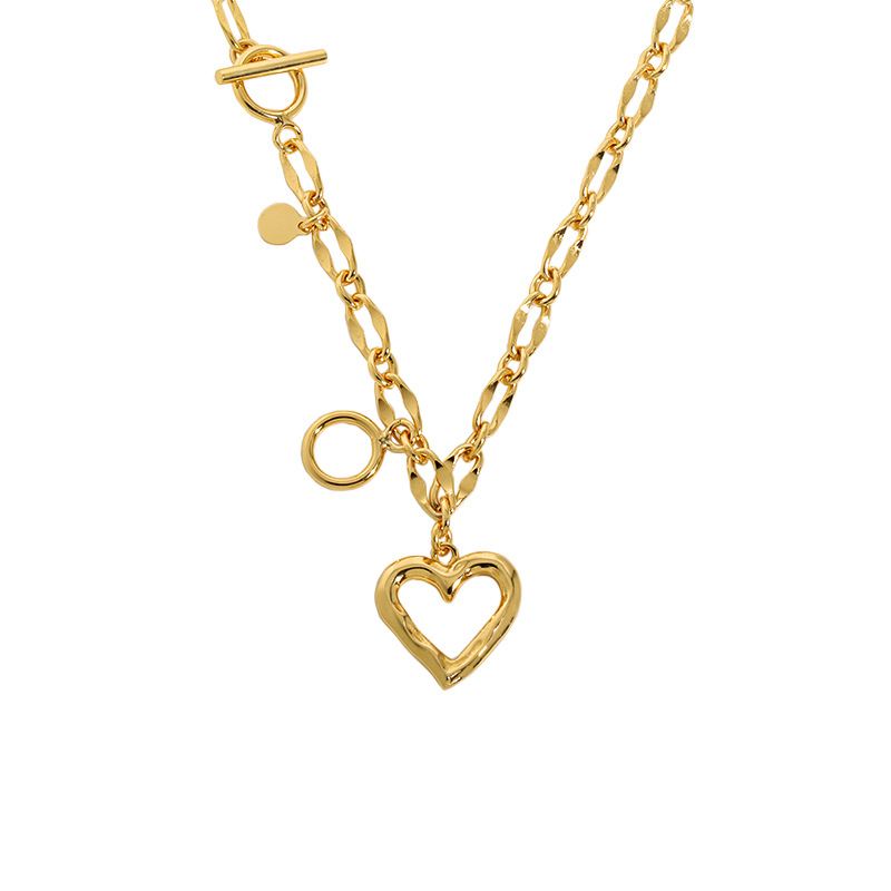 A gold-colored necklace with a hollow heart-shaped pendant and a T-bar closure.