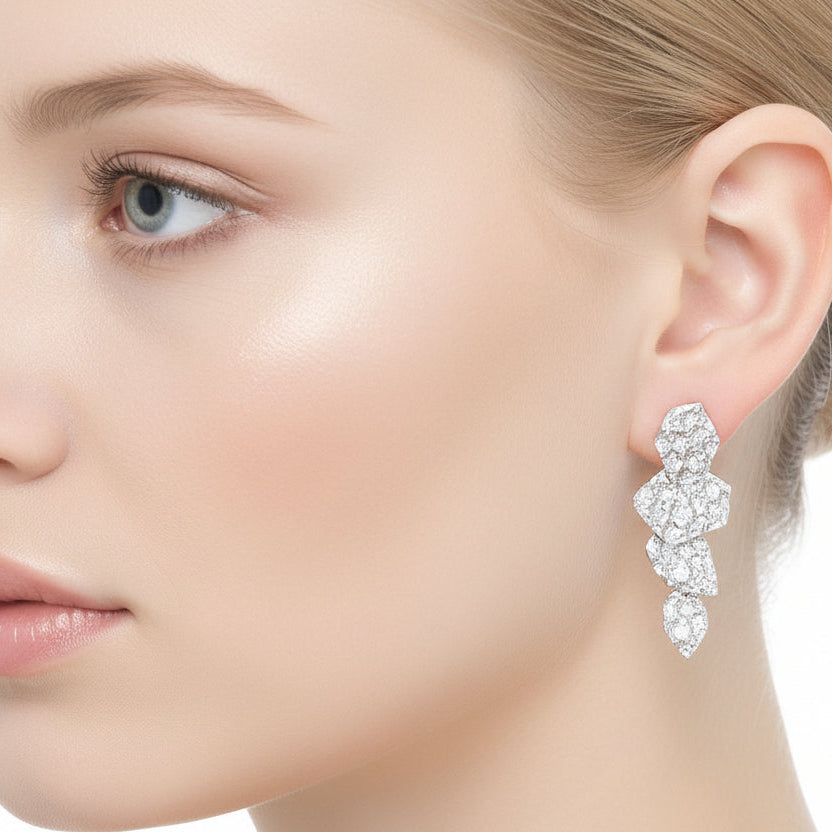 Diamond earring worn by a person against a dark background