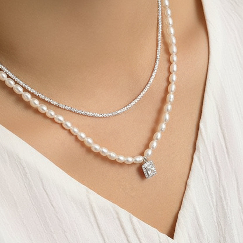 Pearl necklace with a silver clasp and square diamond pendant