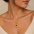 Gold necklace with a heart-shaped lock pendant on a neutral background