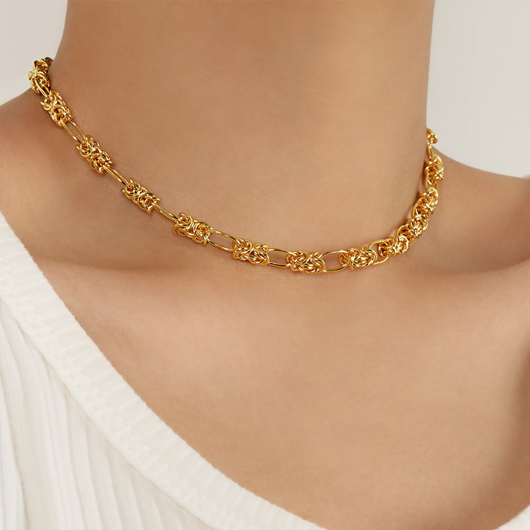 Gold chain necklace on a mannequin with a white background